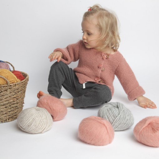 Old pink baby cardigan with wood buttons made from wool and mohair